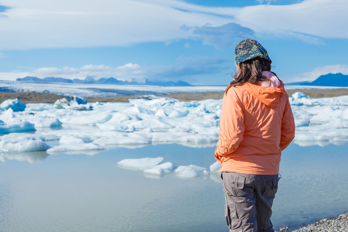 a person looking at ice on a water body